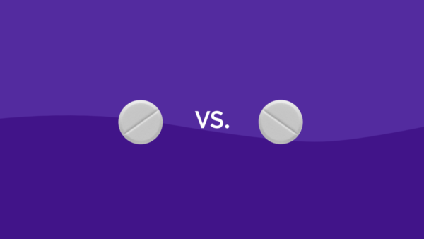 Two Rx pills representing high cholesterol medications lovastatin and atorvastatin