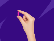 Hand holding pink Rx capsule: Non-Drowsy Benadryl