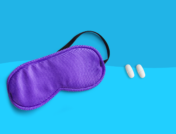 An eye mask and pills represent sleep aids