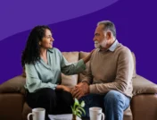 A woman consoling an older man: Learn how to support someone with PTSD