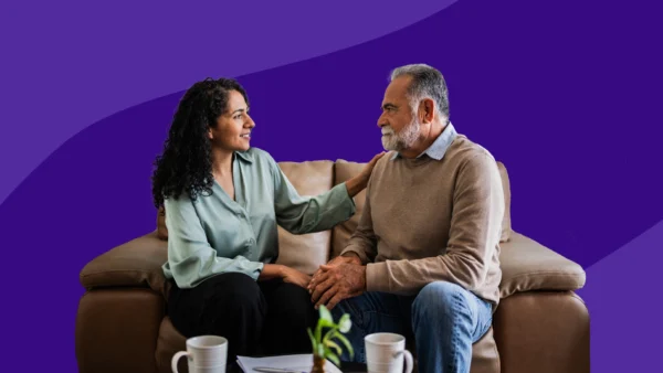 A woman consoling an older man: Learn how to support someone with PTSD