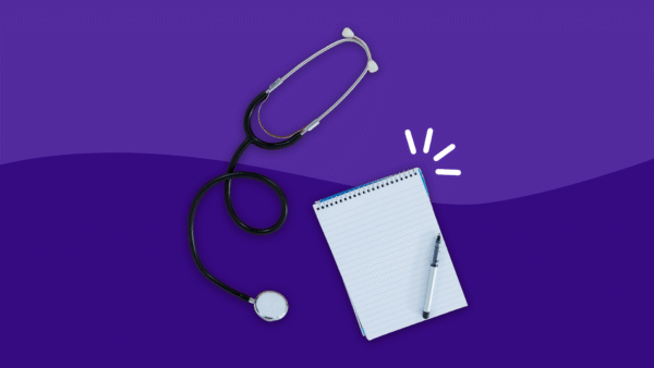 Doctor's stethoscope with a notepad and pen: Healthcare survey and healthcare statistics
