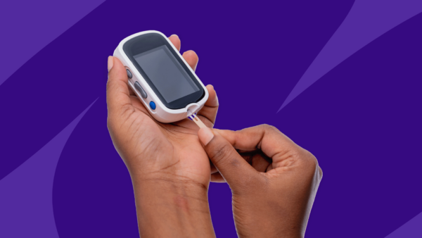 A hand holding a dibetic glucose monitor: Does Medicare cover testing supplies?