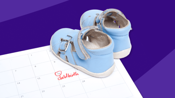 A pair of baby shoes on a calendar represent a due date calculator