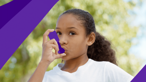 A girl with an inhaler represents early signs of asthma