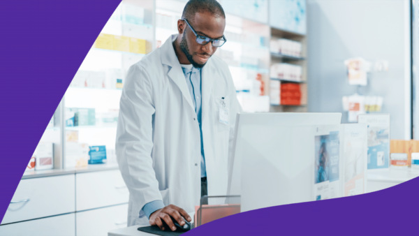 A man behind a pharmacy counter represents how long does it take to become a pharmacist