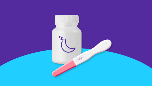 A jar of pills and a pregnancy test represent a sleep aid while pregnant