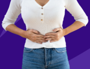 Woman holding stomach - what does a diverticulitis attack feel like