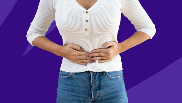 Woman holding stomach - what does a diverticulitis attack feel like