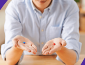Man holding a blue pill in one hand and a red pill in another hand: Can you take Eliquis and Tylenol together?
