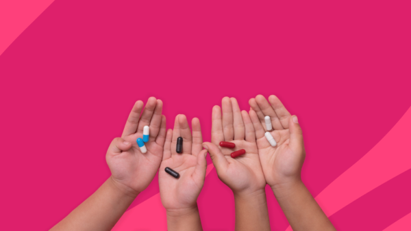 four children's hands with pills - children's antibiotics