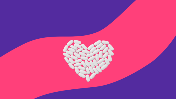 Pills in the shape of a heart represent the side effects of statins