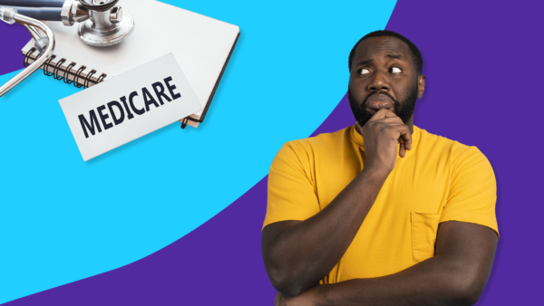 Man looking inquisitively at a Medicare sign and notebook with stethoscope: Does Medicare cover cancer treatment?