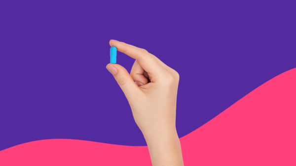 Hand holding blue Rx pill: Prazosin side effects and how to avoid them