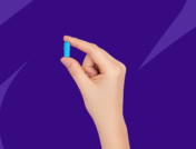 Hand holding blue Rx pill: Doxycycline side effects and how to avoid them