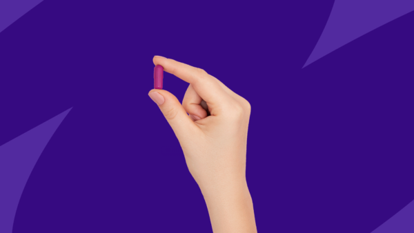 Hand holding Rx capsule: Nuedexta without insurance