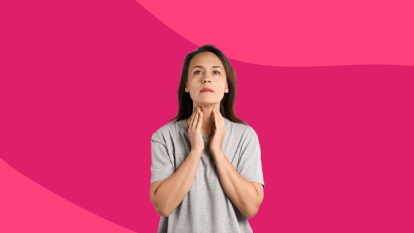 woman with hands touching neck - can you live without a thyroid