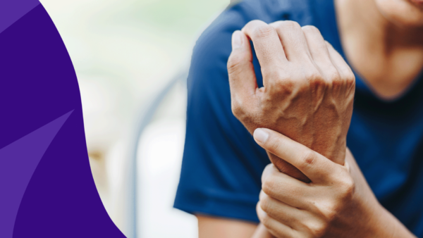 Person holding their wrist - signs of inflammation