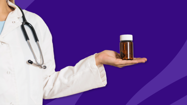 Medical professional holding Rx pill bottle: What causes eye twitching?