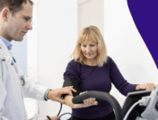 A woman looking at stress test results with her provider