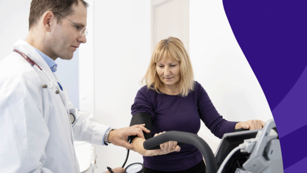 A woman looking at stress test results with her provider