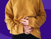 Woman holding stomach: Colitis symptoms