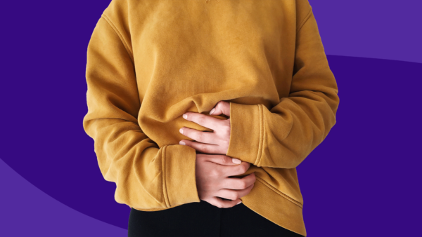 Woman holding stomach: Colitis symptoms