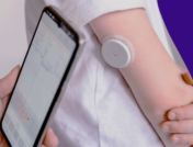 Person with a glucose monitor on their arm - continuous glucose monitoring for non diabetics