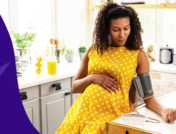 pregnant person with a blood pressure cuff - low blood pressure during pregnancy
