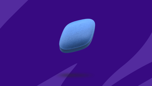 Little blue pill, aka Viagra, on purple background