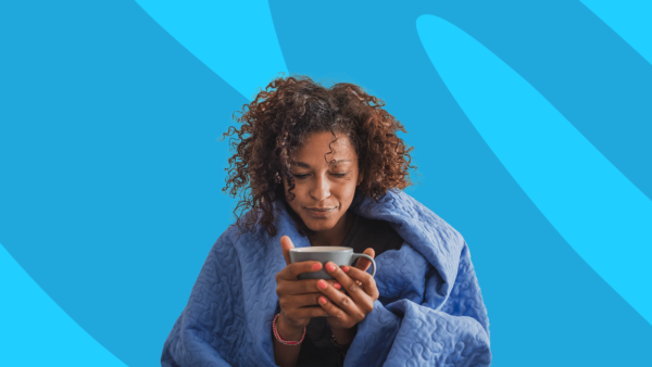 Woman wrapped in blanket holding mug: How long does mono last?