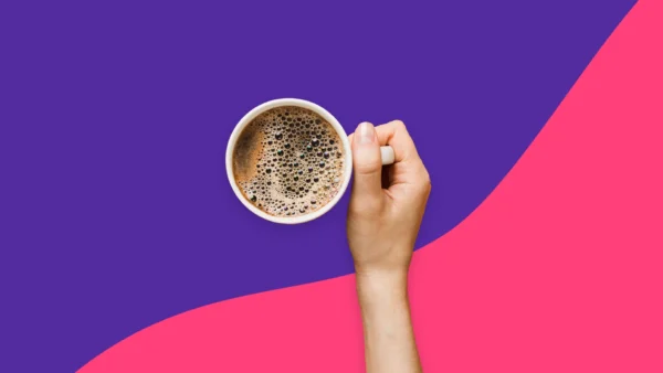 Hand holding a cup of coffee - Does coffee dehydrate you?