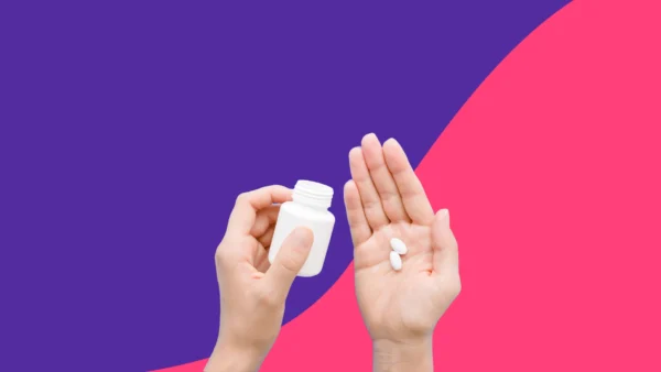 Hands holding a pill bottle and pills - Side effects of Zoloft for women