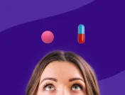 A woman looking up at an Advil and Tylenol pill | Advil or Tylenol for headache