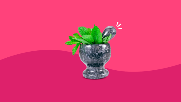 A mortar and pestle with leaves inside: Dandelion root benefits