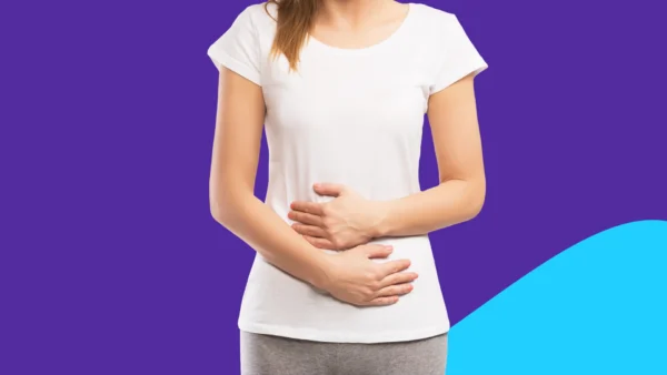A woman holding her stomach | stomach flu remedies