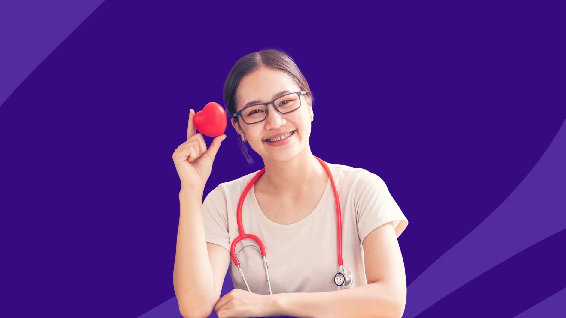 A woman with a stethoscope and heart | cholesterol levels by age chart