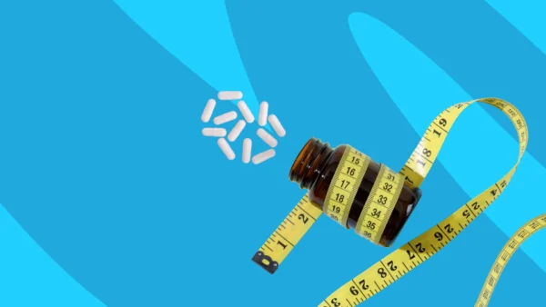 bottle of supplements wrapped in measuring tape - berberine weight loss