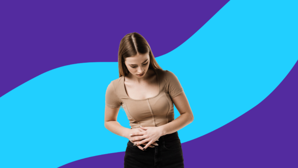 Woman holding right side of stomach: What causes right side stomach pain?