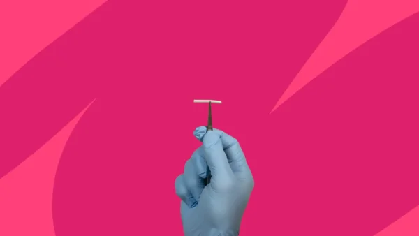A gloved hand holding an IUD device: Nexplanon without insurance