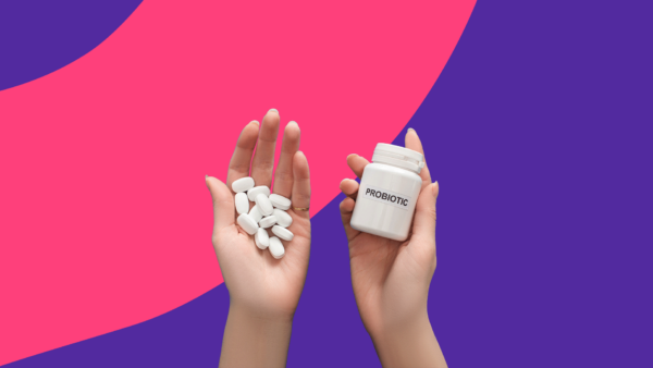 Hands holding probiotic bottle and capsules: Best probiotics for vaginal health