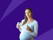 pregnant person holding up a pill - omeprazole pregnancy
