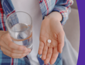 Someone holding a pill in one hand and a glass of water in the other: Lamictal for depression
