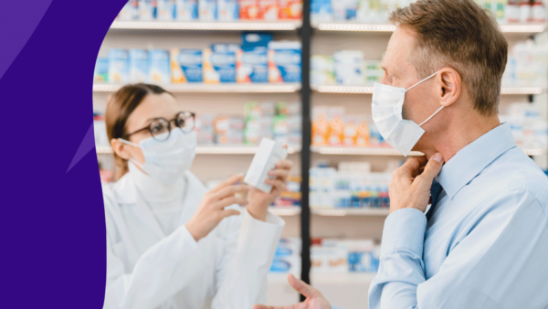 Man holding his throat and speaking to a pharmacist about medicine