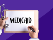 Hands of a healthcare provider holding a stethoscope in one hand and a pen in the other, writing "Medicaid"> Does Medicaid cover Ozempic?