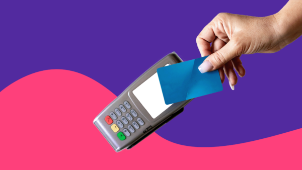 Someone's hand holding a card to a card reader: Farxiga copay card: Eligibility, savings & more