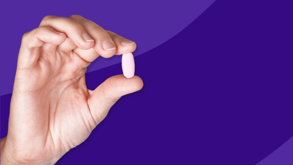 A hand holding a pill: How to save on Entresto