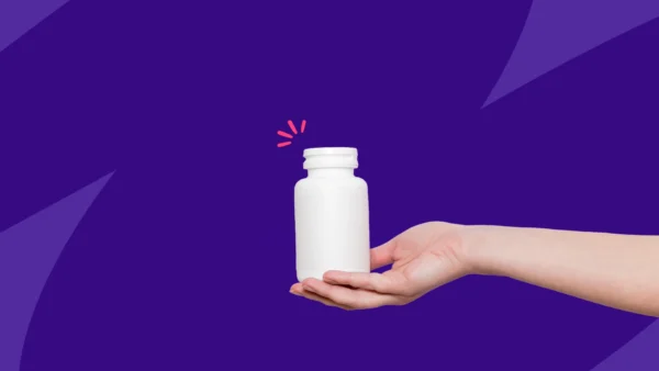 A hand holding an unlabled pill bottle: Can you take ibuprofen and antibiotics?