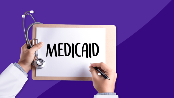 The hands of a healthcare provider holding a stethoscope and clipboard, writing "Medicaid" on it: Is Mounjaro covered by Medicaid?
