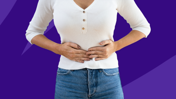 A woman with her hands on her stomach: Can you take Adderall on an empty stomach?
